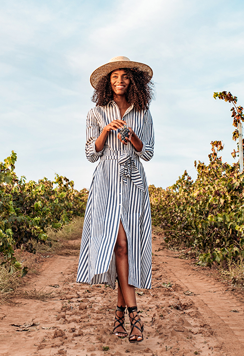 Overweight woman drinking water after jogging in the park. Portrait of young plus-size thirsty woman with a bottle of water outdoors. Sports, healthcare, weight loosing, fitness, well-being  concept