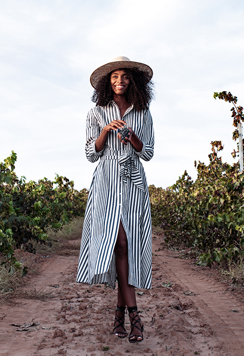 Young overweight smiling woman with a bottle of clear water outd Overweight woman drinking water after jogging in the park. Portrait of young plus-size thirsty woman with a bottle of water outdoors. Sports, healthcare, weight loosing, fitness, well-being concept